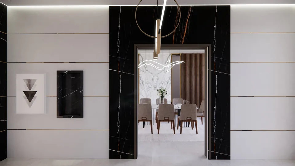 Hallway with a black marble-look door surround opening onto a dining room with upholstered chairs.