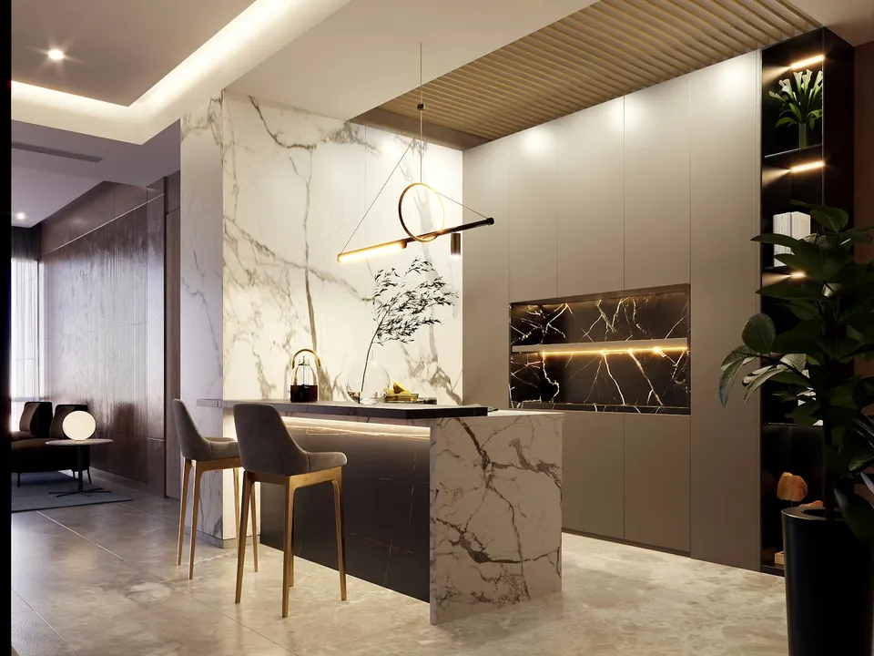 Kitchen bar with a white veined marble-look counter, dark bar stools, a gold linear pendant and grey tall cabinets.