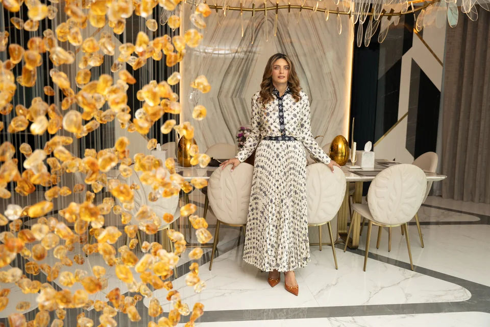 Anita Surani in the dining room of MK Villa, Palm Jumeirah, beside the amber crystal installation