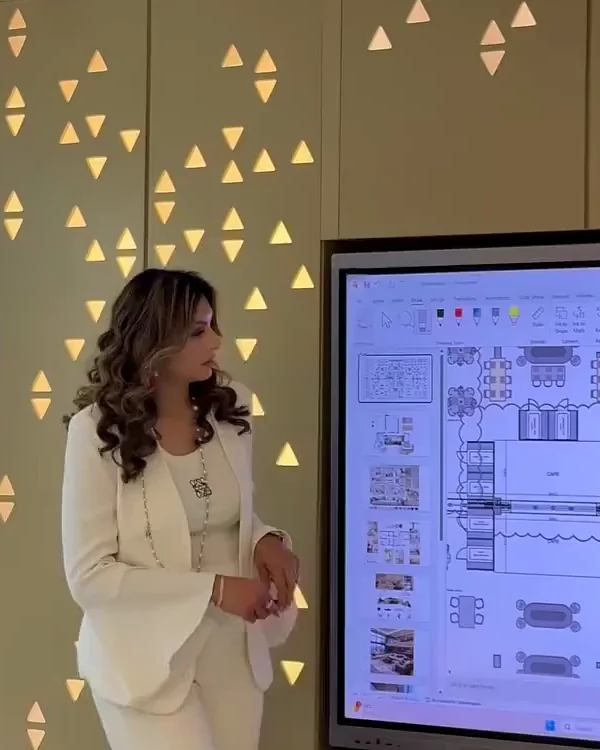 Anita Surani presenting a floor plan on screen at the Xena studio