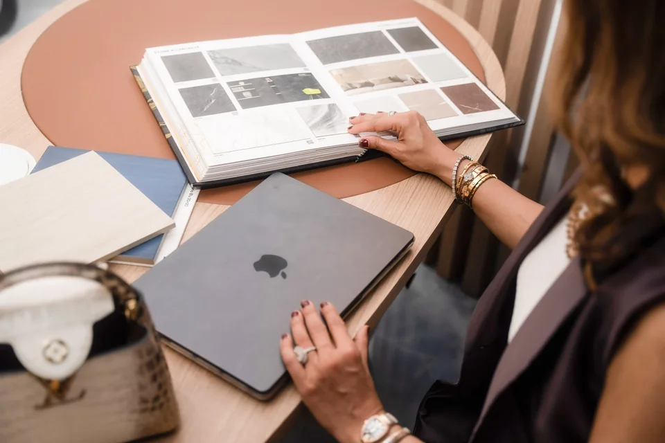 Material sample books and finishes on a desk at the Xena studio