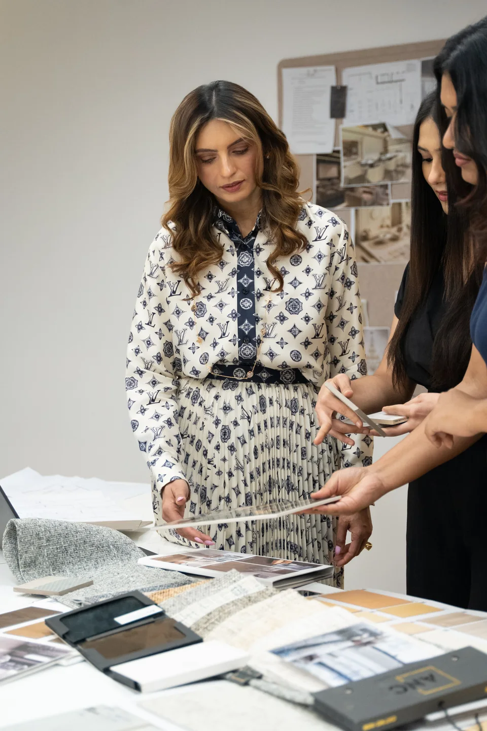 Anita Surani and a designer checking finishes against the mood board at the Xena studio