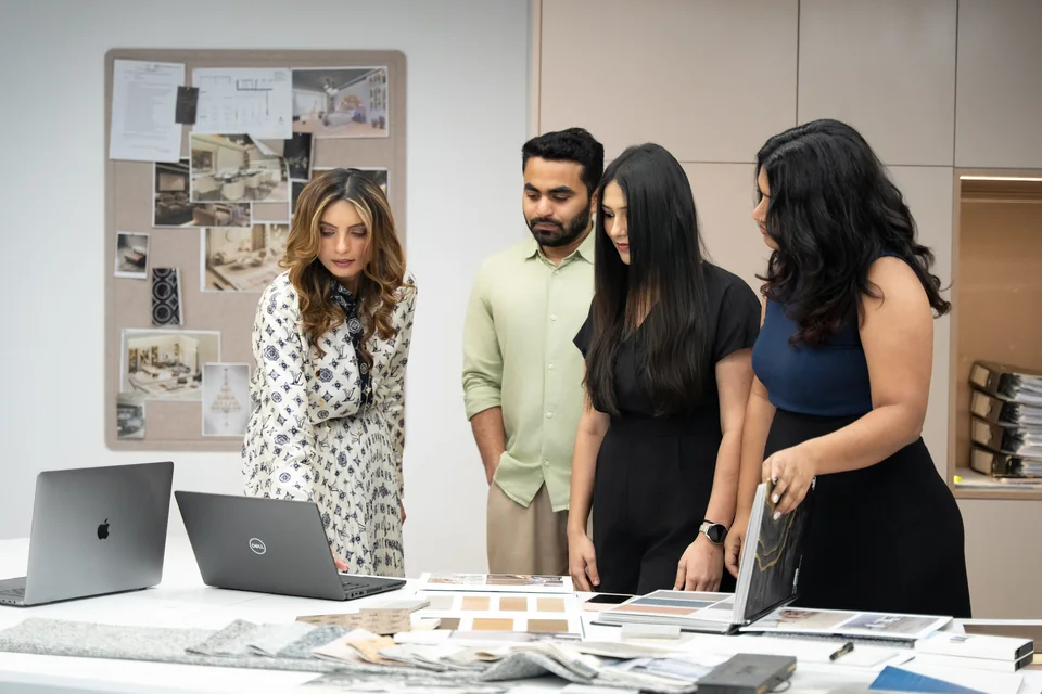 Anita Surani and the design team reviewing a mood board and material samples at the Xena studio